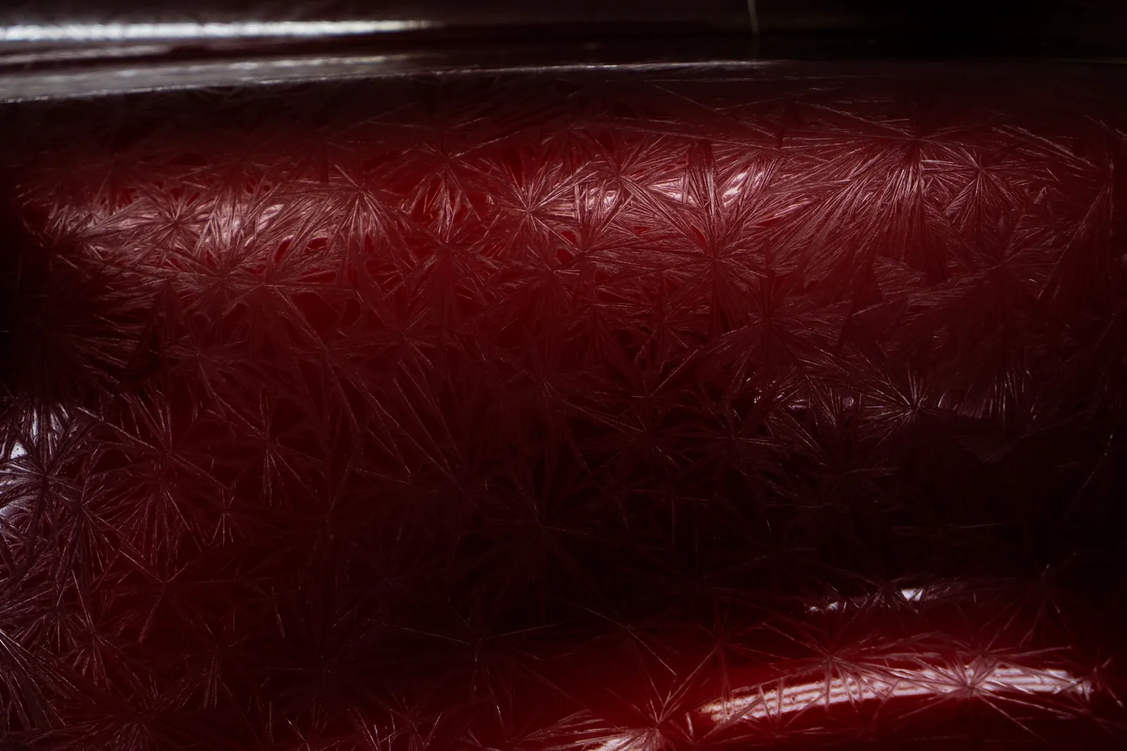 Close-up of a custom red textured paint finish created at DEIZ Garage