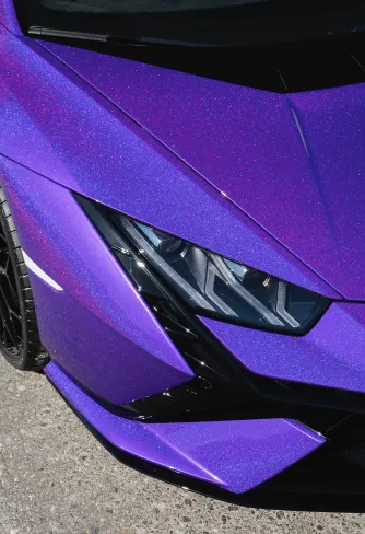 Close-up of the polished purple metallic finish around the headlight