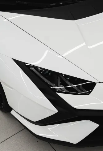 White Lamborghini Huracán headlight and bodywork before the repaint at DEIZ Garage